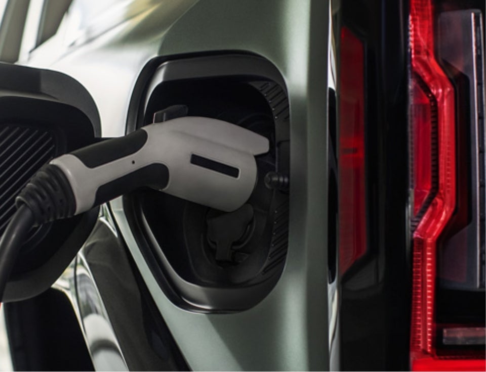 Close up of charging port with charger plugged in on a GMC Hummer EV SUV - Alexander Family GMC in Bloomsburg PA